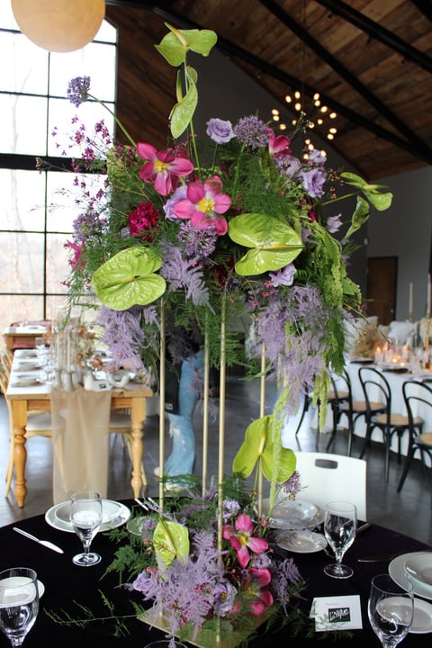 statement wedding centerpiece on harlow stand with whimsical anthurium, tulips, agapanthus, allium
