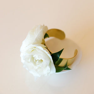 fresh white blooms with green leaves on a cuff corsage bracelet