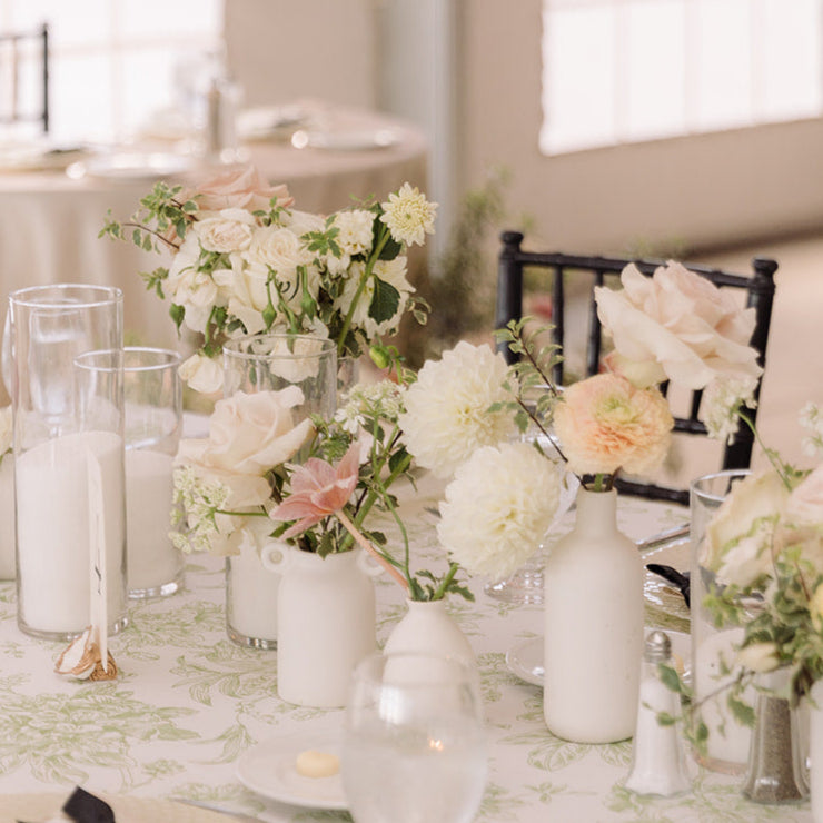 a cluster of bud vases paired with candles make a beautiful wedding table