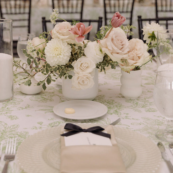 white dahlias, pale roses, pink tulips and fresh greens make a timeless wedding centerpiece