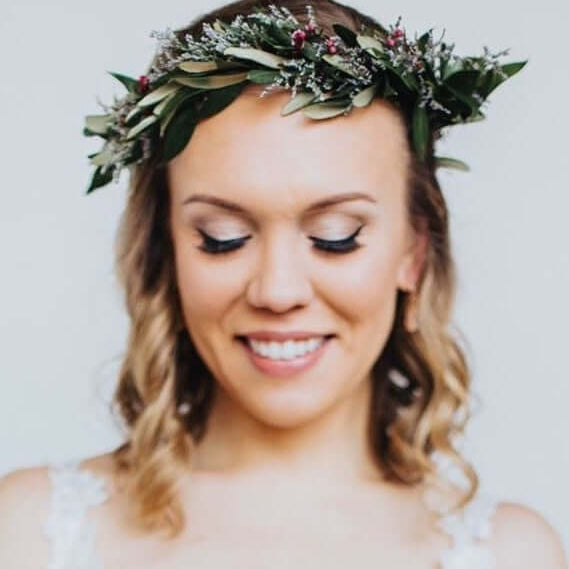 Woman wearing whimsical dainty flower crown perfect for a bride or guest of honor