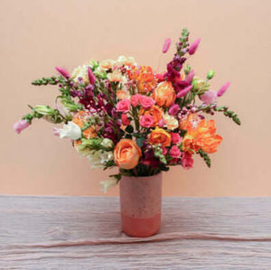 large mixed floral arrangement with pink vase