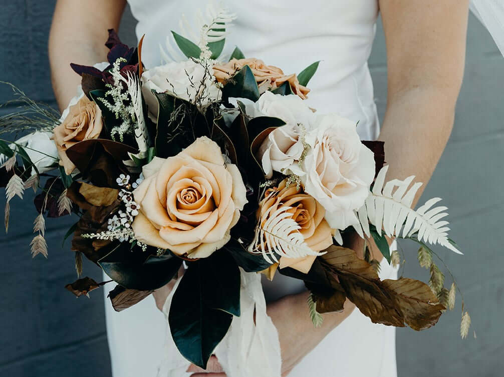 Blush rose boho bridal bouquet with magnolia leaves