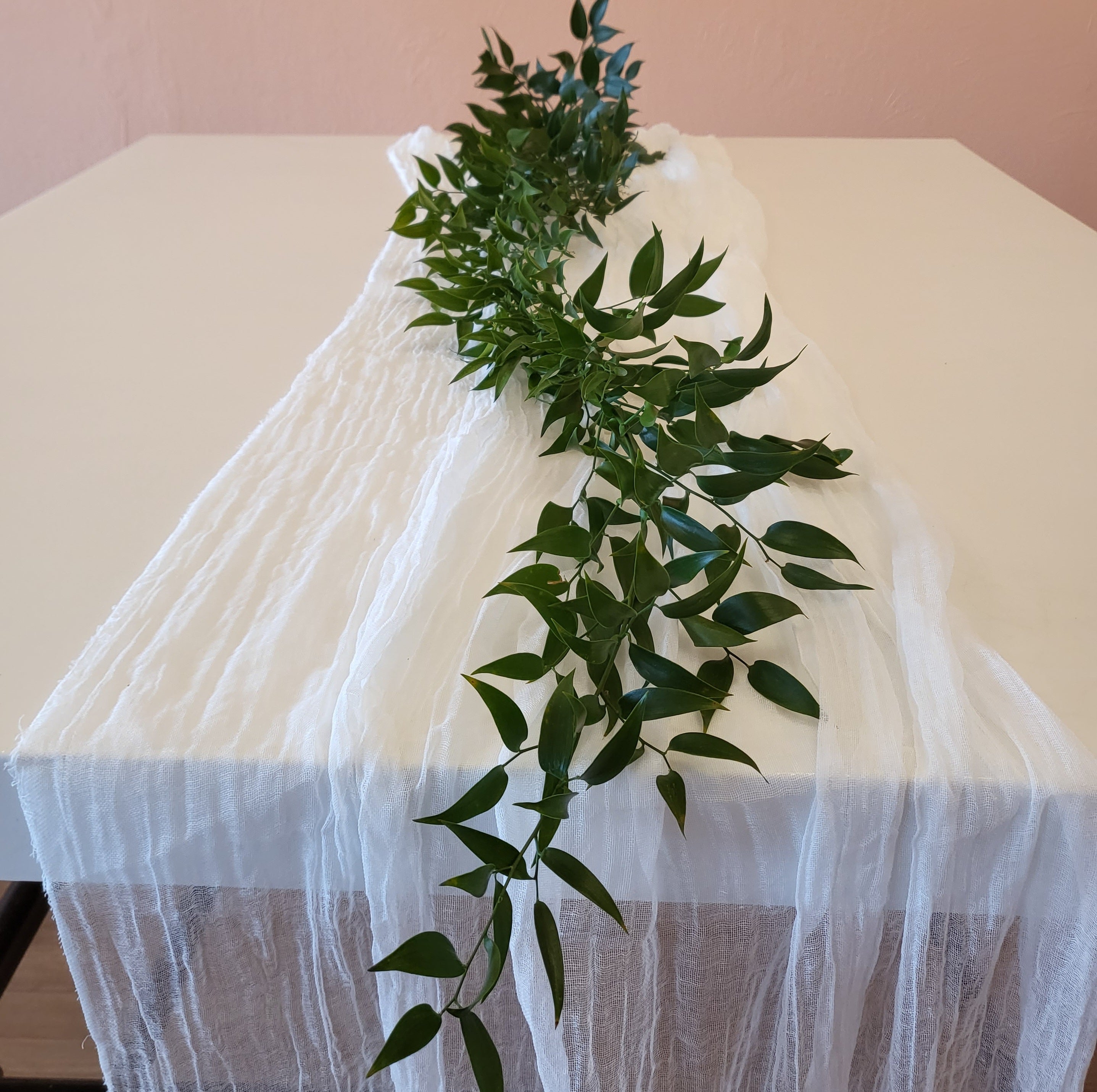 fresh greens run down the length of a table for a wedding on a budget
