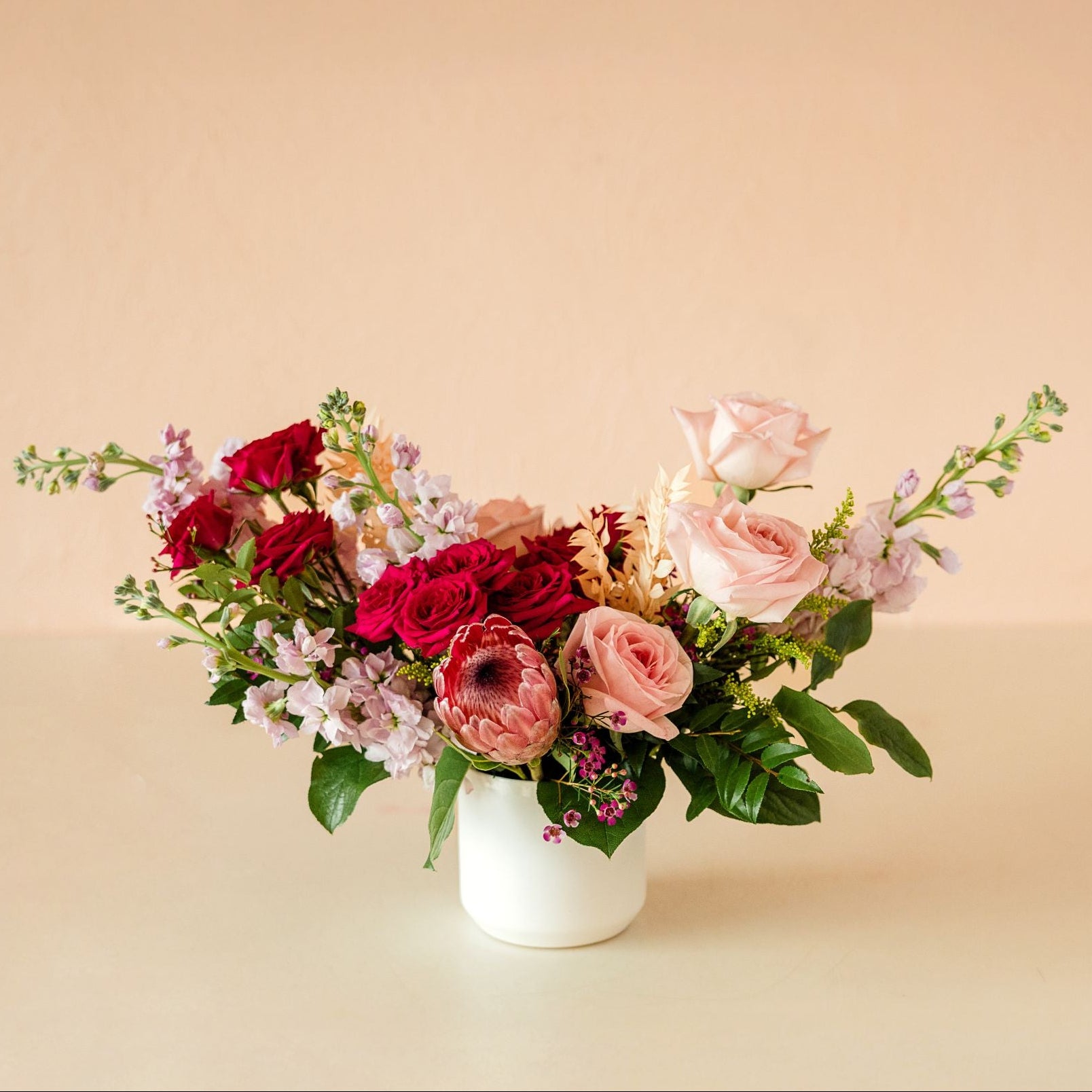 Roses, spray roses, stock, waxflower, protea