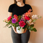Person holding a colorful bouquet of fresh flowers
