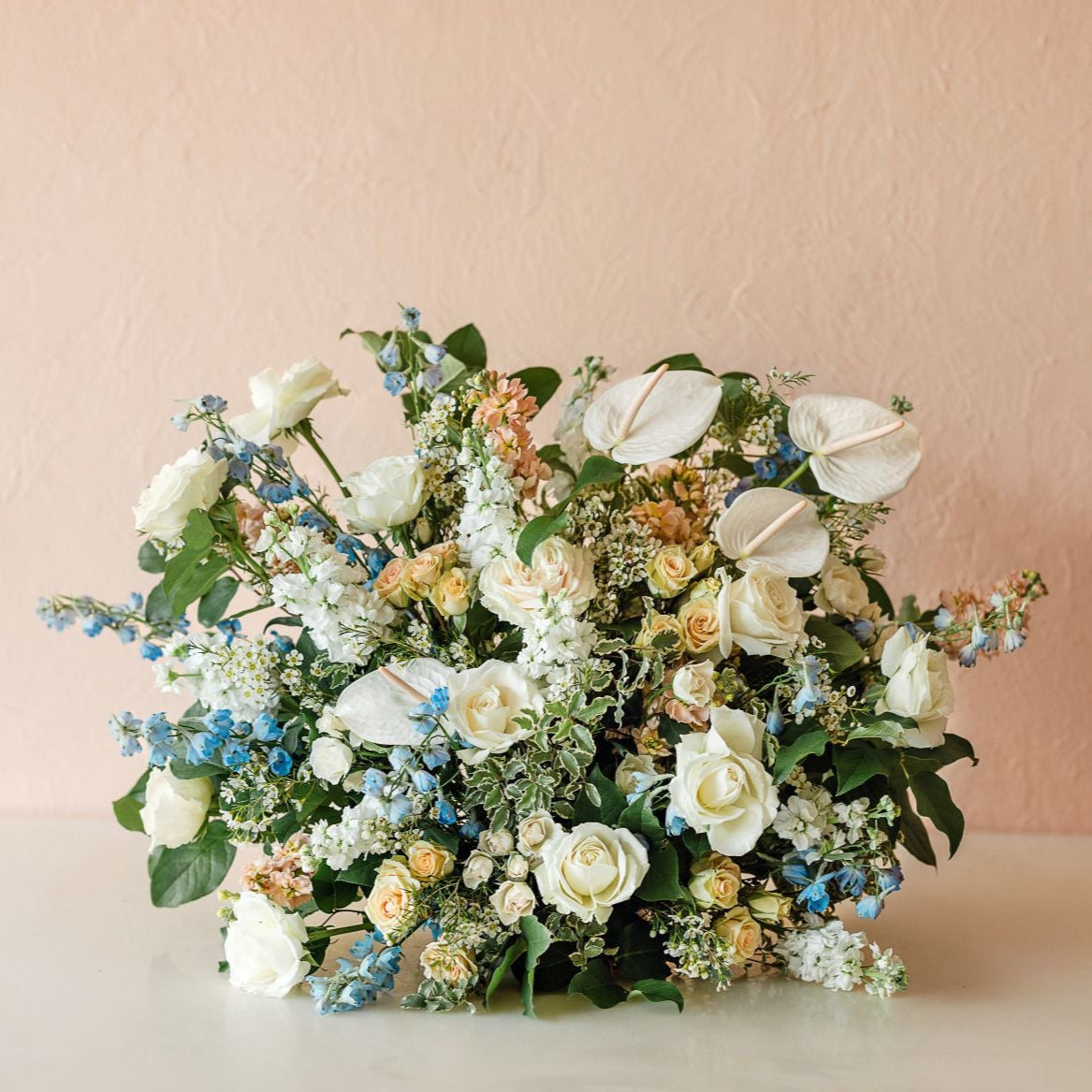 anthurium, roses, delphinium, spray roses, stock, waxflower and more
