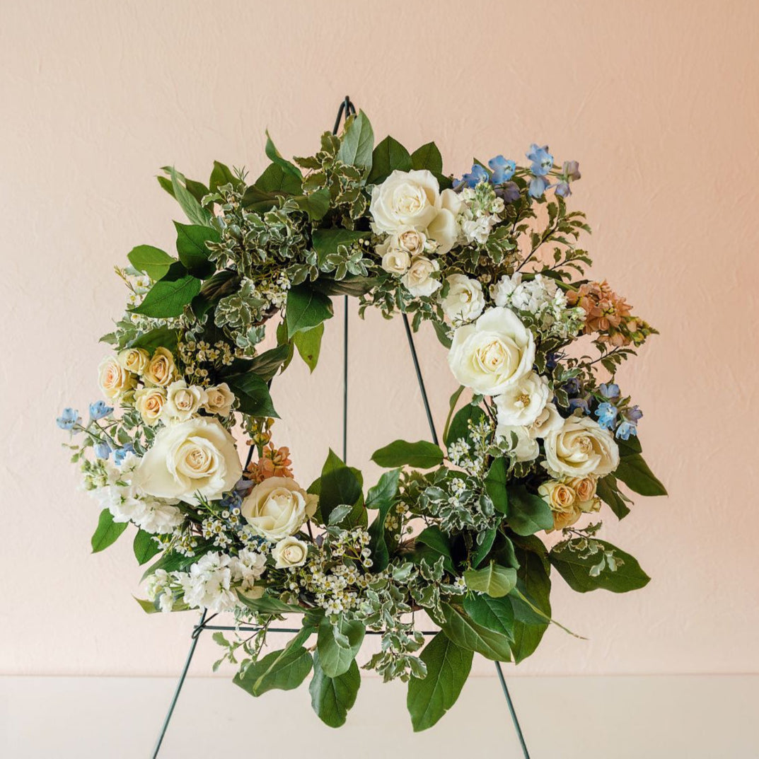 roses, spray roses, delphinium and vibrant greenery