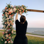 flower pieces added to an arch for wedding ceremonies