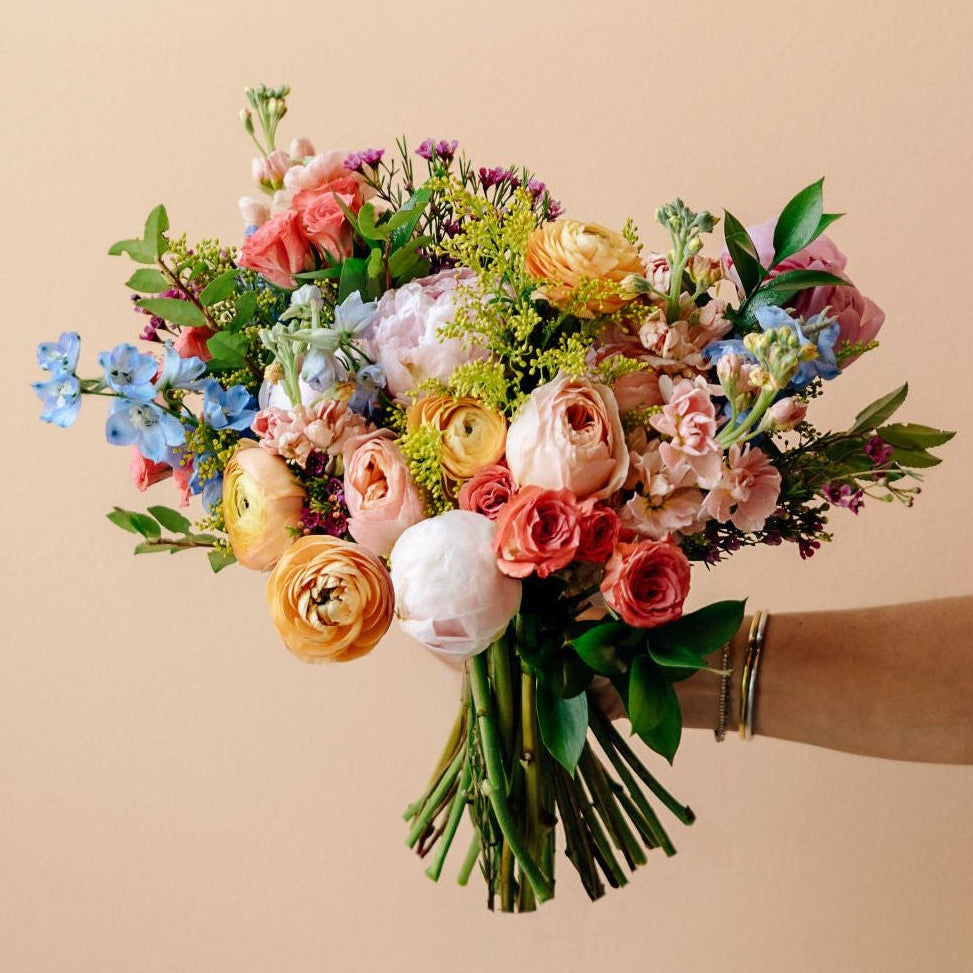 A beautiful hand-held bouquet of flowers fit for a bride