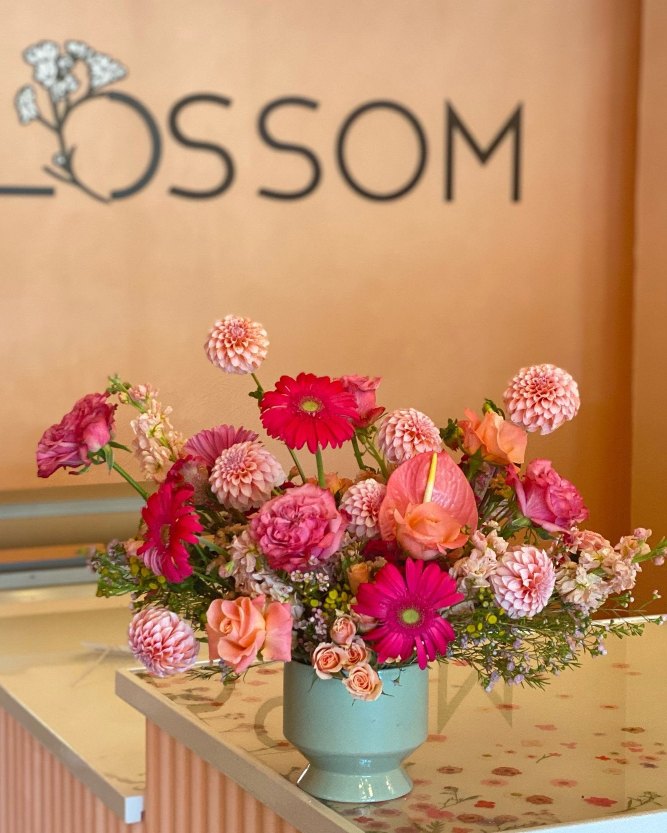 a monochromatic luxe arrangement in pinks from pale to bright coral