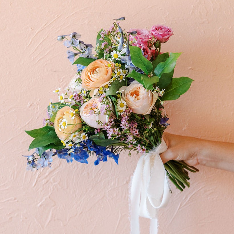 Colorful stems are wrapped for a spring or summer bride