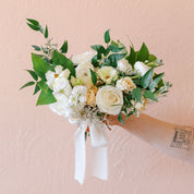 a small and petite neutral posy tied with a ribbon