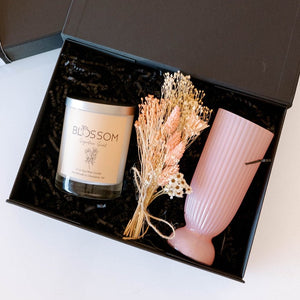 gift items of candle, vase and dried flower arrangement