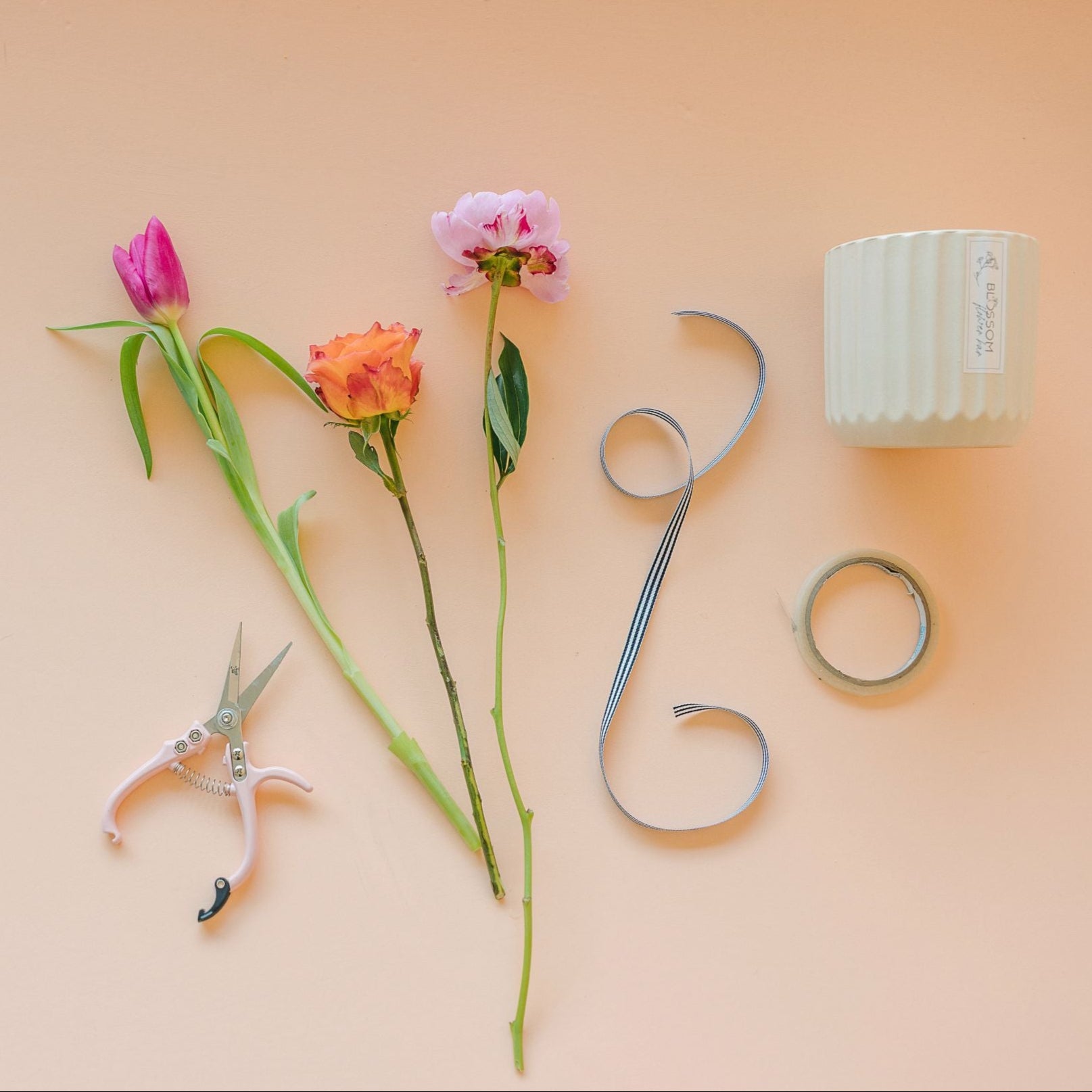 Floral workshop items on a peach background