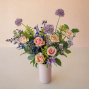 a tall vase exploding with beautiful flowers