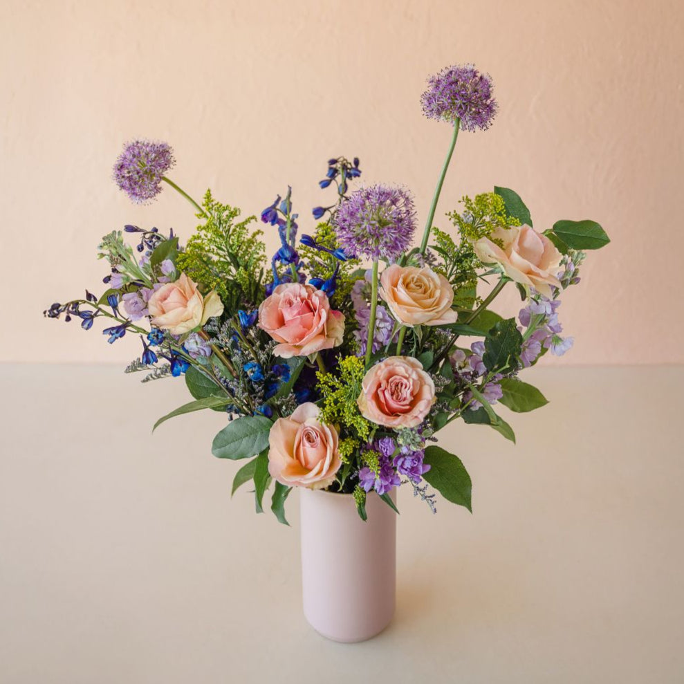 a tall vase exploding with beautiful flowers