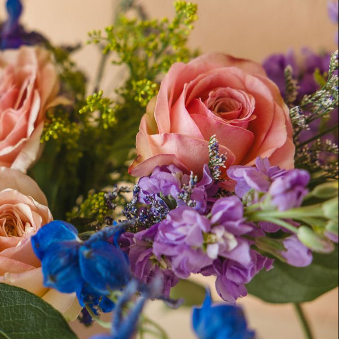 closeup of roses, stock and delphinium