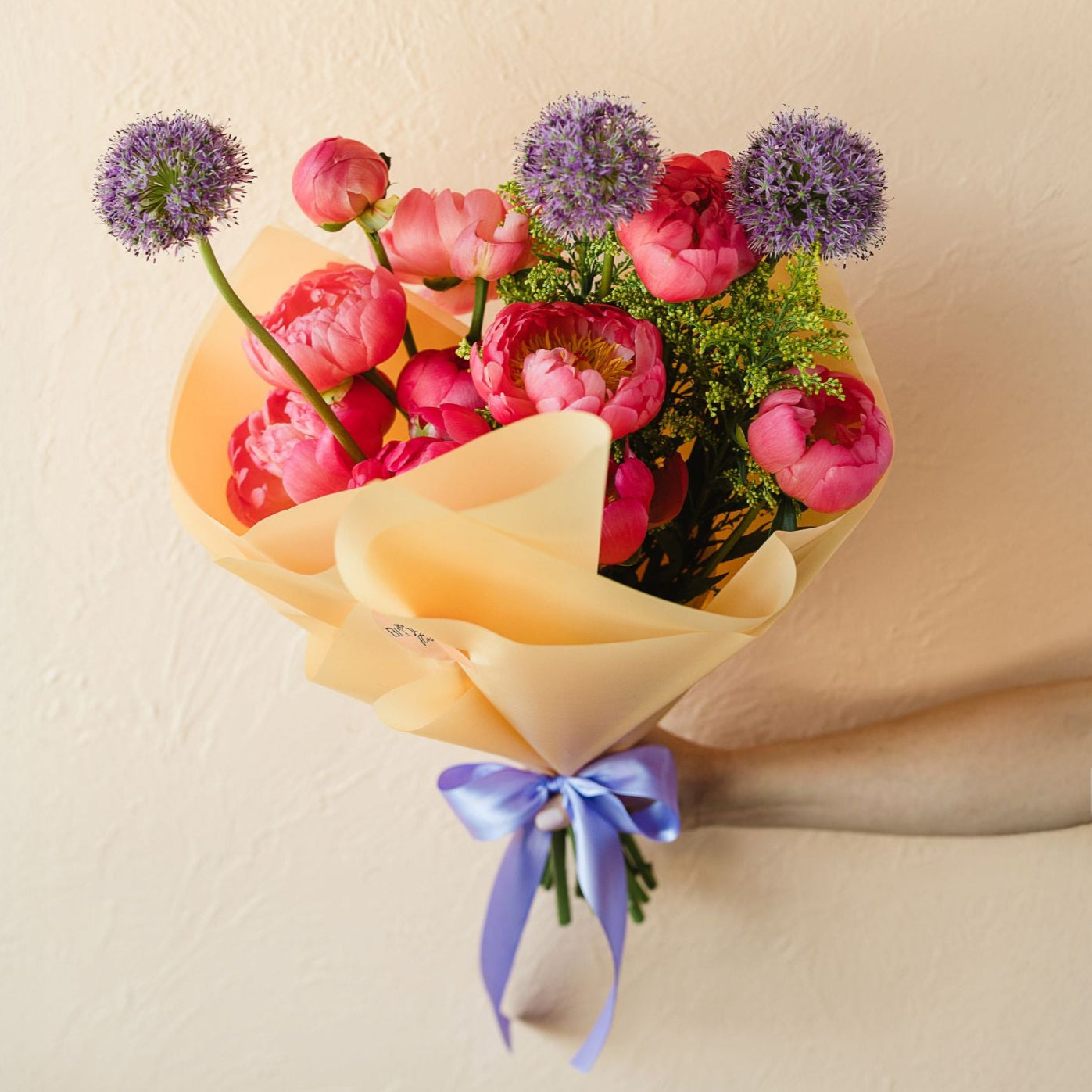 a wrap of peonies with allium and solidago