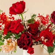 dark, frilly roses are paired with classic vivid pink roses in this arrangement