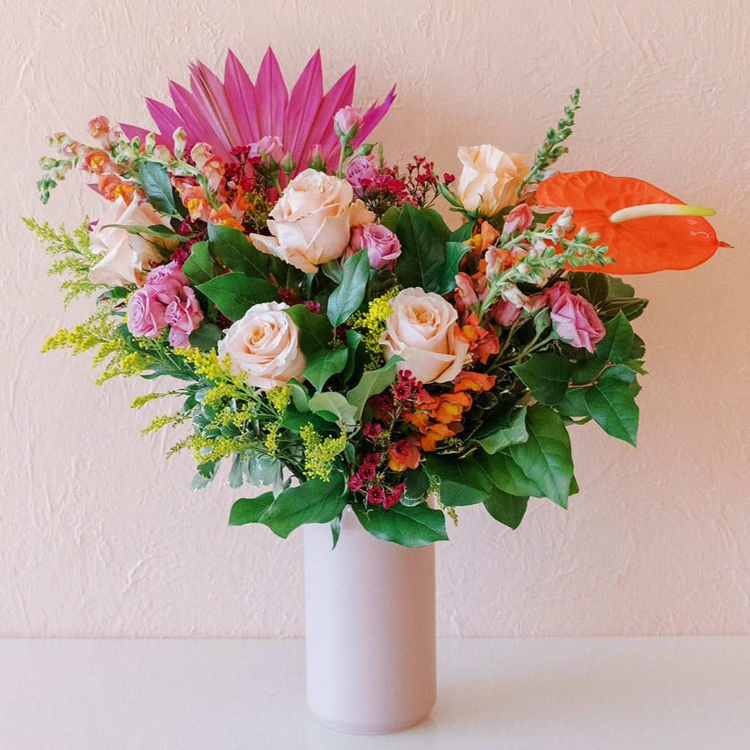 Large colorful arrangement of flowers in a vase available for flower delivery