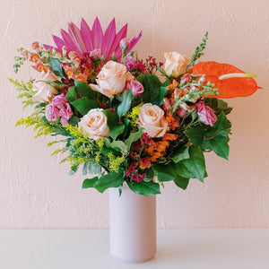 Large colorful arrangement of flowers in a vase
