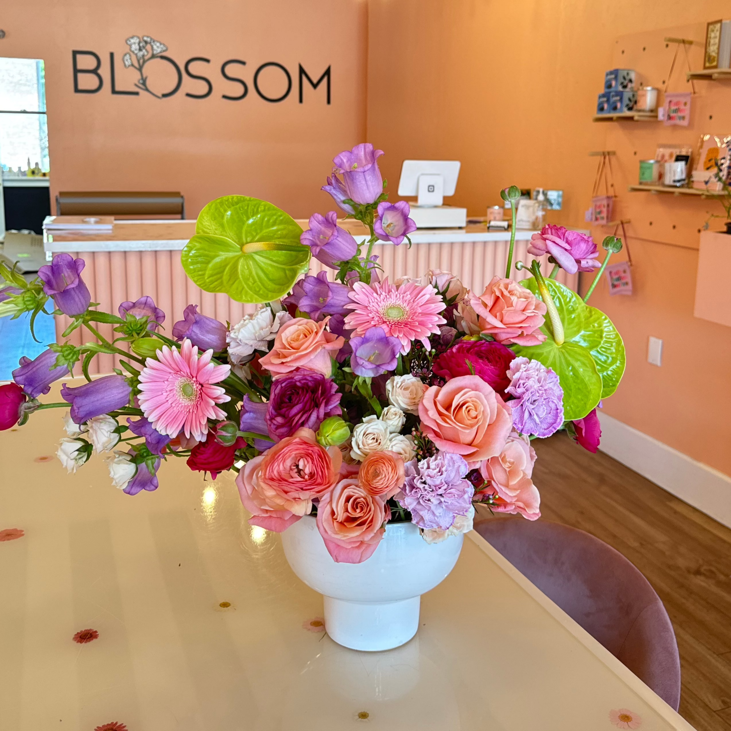 bright green anthuriums are the centerpiece of this premium arrangement