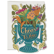 An urn that reads "cheers to you" is overflowing with illustrated flowers