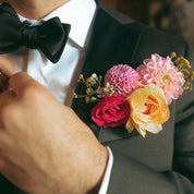 a modern flower for a groom or groomsmen with dahlias, roses and waxflower