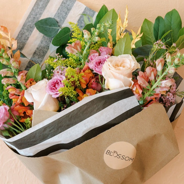 Columbus designers use healthy snapdragons, spray roses, waxflower, solidago and lemon leaf