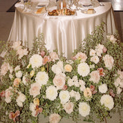 an elegant, sophisticated and classy neutral arrangement decorates a wedding reception