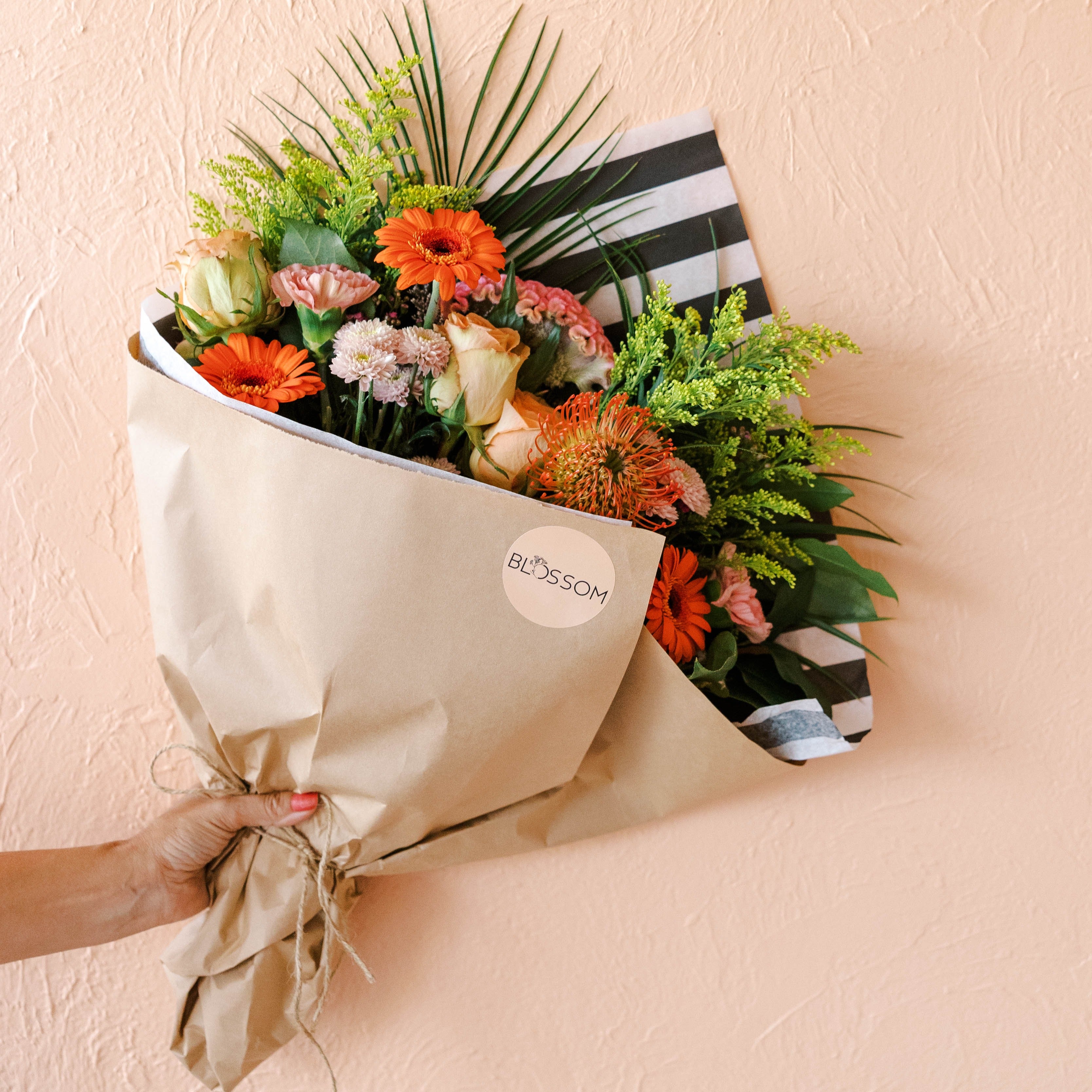 Blossom's Cleveland designers create bouquets with premium stems like roses, protea, gerbera daisies, and celosia