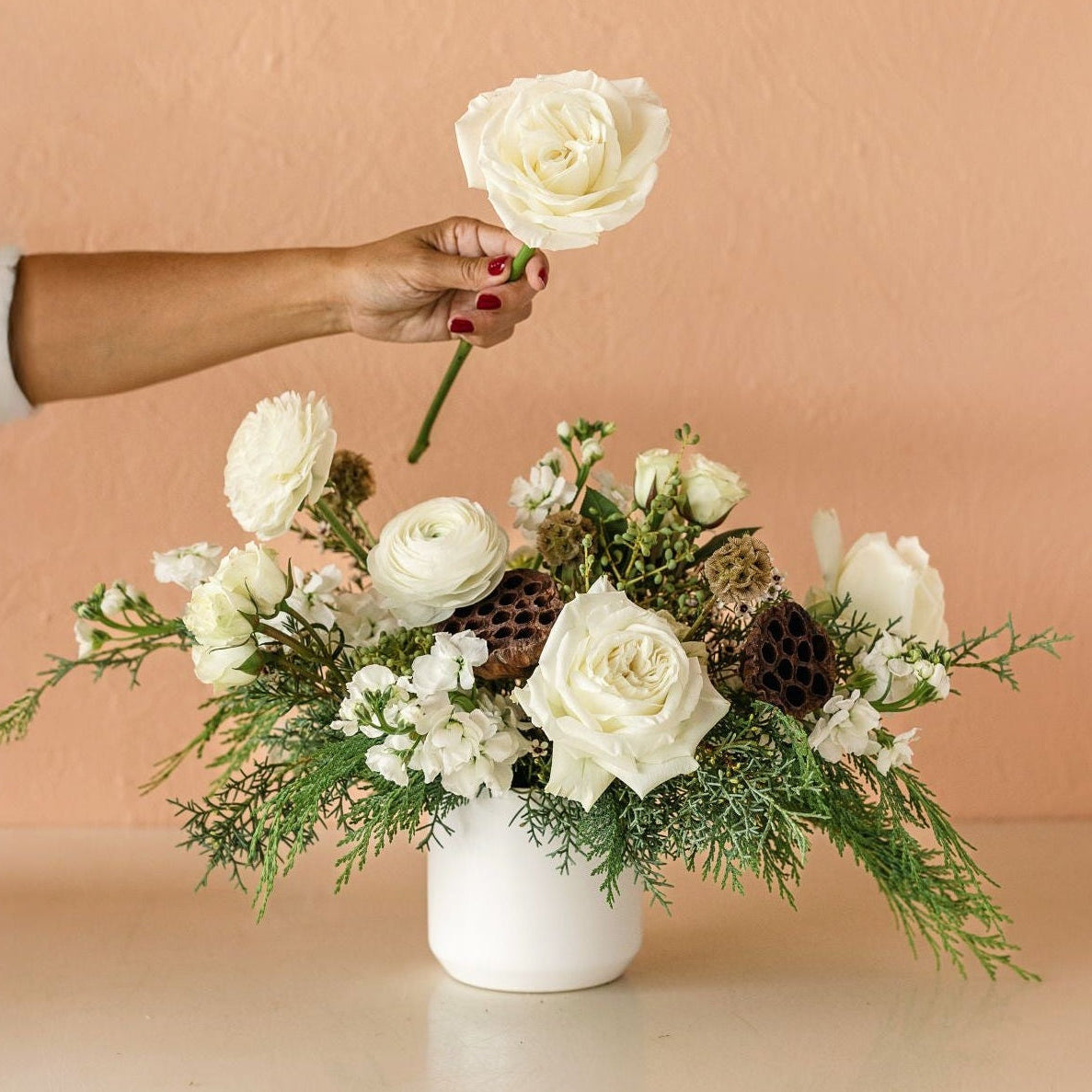 white roses in a winter centerpiece