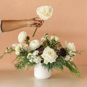 white roses in a winter centerpiece