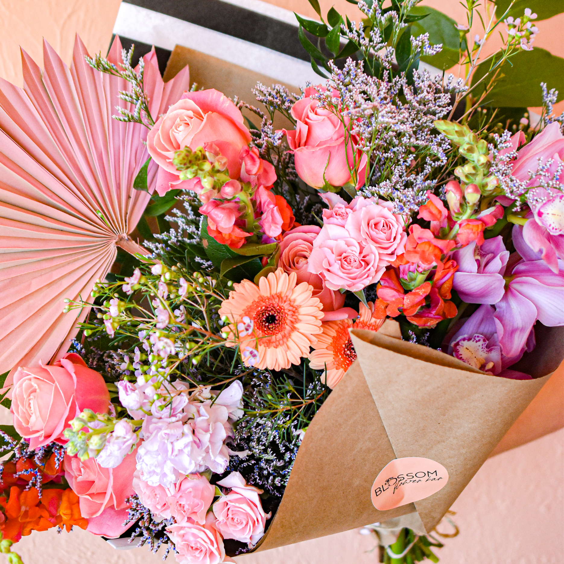 Blossom Flower Bar uses healthy, unusual and unexpected flowers in their designs including a colorful palm frond 