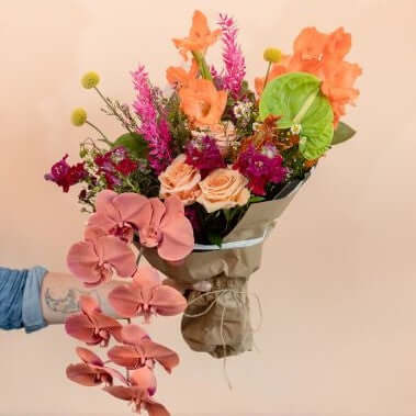 Blossom's designers love to create these wraps full of orchids, roses, celosia and other mixed exotic flowers 